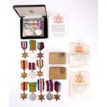A group of fourteen WWII service medals: two groups in original postage boxes,
