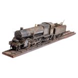 A large scale (70mm) live steam 2-6-2 locomotive and tender: in a black finish with brass and steel