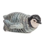 A Beswick penguin chick sliding: under blue, black and white gloss.