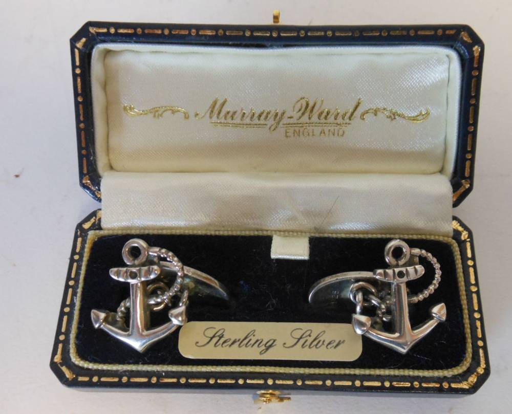 A pair of silver cuff links, stamped marks: in the form of fouled anchors, cased.