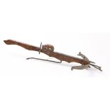 A reproduction wooden crossbow in the Chinese taste:, 97cm long.