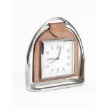 A Smith Stirrup timepiece: the square eight day movement with Arabic numerals in leather suspension