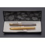 Two Parker fountain pens,: one in Cisele gold the other in Cisele silver, both with 18k gold nibs.