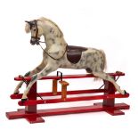 A painted grey and dappled fibreglass rocking horse by Haddon's: with white horsehair mane and tail,