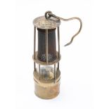 A brass miners lamp by KW: numbered '620' to top and base and with folding flint lever to bottom,