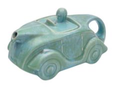 A Sadler racing car teapot: under mottled green glazes, impressed and printed marks, 24cm long.
