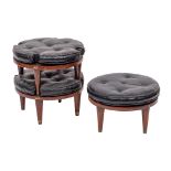 A set of three stained hardwood and leatherette cushioned stacking stools, circa 1970s,