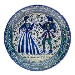 A Silves [Portuguese] art pottery charger: of circular form painted in blue and green on a cream