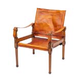 A stained beech and leather covered elbow chair in the manner of campaign furniture, modern,