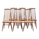 Ercol, a stained elm trestle dining table and six Goldsmith pattern dining chairs,