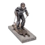 Leon Brunswick, an Art Deco patinated metal model of a female Alpine skier: on a naturalistic base,