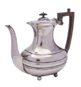 A George V silver teapot, maker Maple & Co, Sheffield, 1913: of barge-shaped outline,