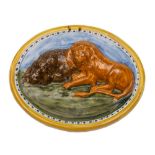 A large oval Pratt pearlware 'lion' plaque: moulded in relief with two reclining lions reclining on