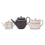 An early 19th century black basalt punch pot and cover and two Castleford-type teapots and covers: