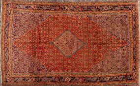 A Bidjar carpet:, the brick red field with a central powder blue hooked hexagonal pole medallion,