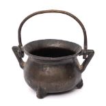 A 17th/18th Century bronze twin-handled apothecary or toy cauldron: with swing handle,