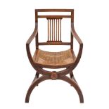 A Regency oak and caned elbow chair in the manner of a Savanarola chair, early 19th century,