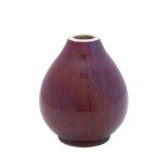 A Chinese sang de bouef glazed Chinese porcelain vase: of oviform under lavender tinted flambé