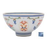 A small Chinese doucai bowl: painted with pendant stylised lotus blooms and foliage suspended from