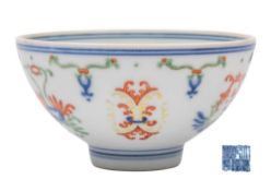 A small Chinese doucai bowl: painted with pendant stylised lotus blooms and foliage suspended from