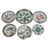A group of six Chinese famille verte dishes and chargers, Kangxi: variously painted with figures,