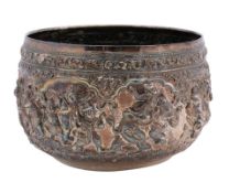 A large Burmese silver bowl: with embossed decoration of ox drawn carts, elephants,