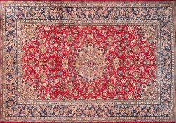 A Najafabad carpet:, the red field with a central beige,