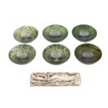 A set of six green jadeite finger bowls: of plain circular form, with mottled inclusions,