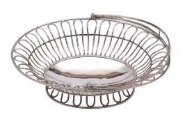 A 19th century Sheffield Plate swing-handled bread basket: crested, of oval outline,