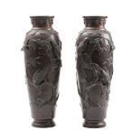 A pair of Japanese bronze vases: decorated in low relief with birds amongst blossoming shrubs,