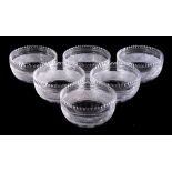 A set of six cut glass finger bowls: of circular form with notched rim and linear,