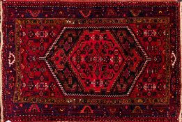 A Zanjan rug:, the serrated hexagonal panel field with a central brick red pole medallion,