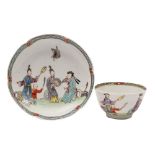 An early First Period Worcester famille rose matched tea bowl and saucer: painted with a family