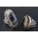 Two gemset rings,: including cabochon-cut banded agate and tiger's eye, length of ring heads ca.