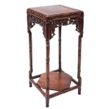 A Chinese hardwood miniature urn stand: with square top and pierced foliate apron,