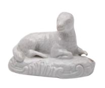 A Plymouth white model of a recumbent ewe: on scrollwork mound base, 9cm (part of one leg lacking).