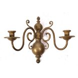 A brass half-round wall mounted twin-branch light bracket: in the early 18th Century Dutch taste,