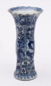 A Chinese blue and white vase: of moulded Gu form with serrated rim,