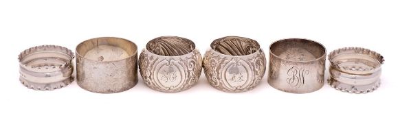 A mixed lot of six silver napkin rings, various makers and dates: four initialled,