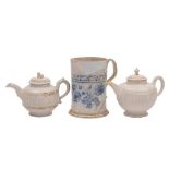 Two Staffordshire white saltglaze teapots and covers and a scratch-blue mug: the first with serpent