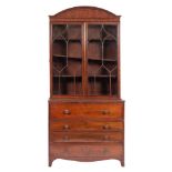 A Regency mahogany and line inlaid secretaire bookcase, circa 1815,