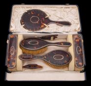 A George V tortoiseshell and silver mounted dressing table set, maker William Comyns & Sons Ltd,