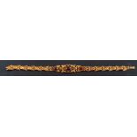 A Victorian, gold, gemset, fancy-link bracelet,: set with foiled-back, cabochon-cut gemstones,