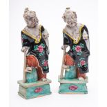 A pair of Chinese porcelain figures: of the Immortal Li Tieguai wearing loose robes with one foot