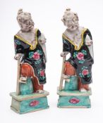 A pair of Chinese porcelain figures: of the Immortal Li Tieguai wearing loose robes with one foot