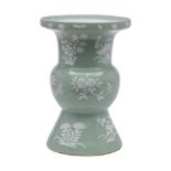 A Chinese celadon ground vase: of 'Gu' form, enamelled in low relief with white flowers and fruit,