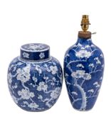 A Chinese blue and white prunus pattern jar and cover and a similar vase: the jar with double