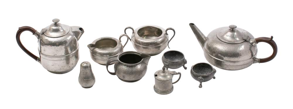 A beaten pewter four-piece tea set: includes tea pot hot water jug, cream jug and sugar basin,