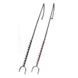 A pair of cob irons:, each with spiral uprights and hinged tops, one iron with ten hooks,