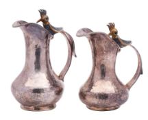 A pair of Los Castillo Mexican silver plated jugs: of ovoid form with crested humming bird mounted